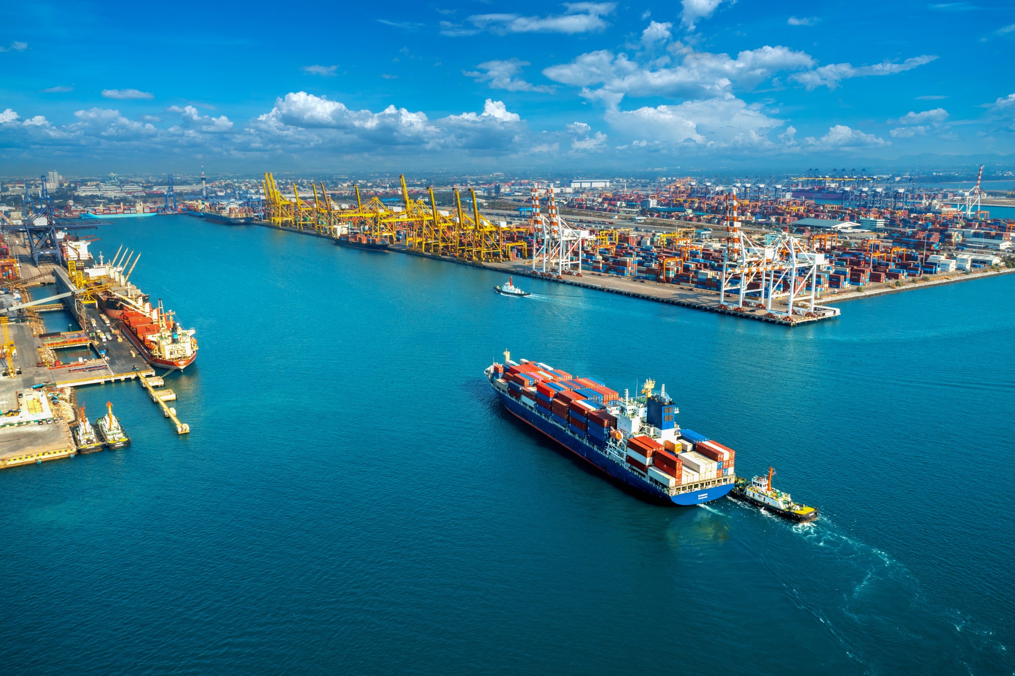 Aerial view of a container ship entering a cargo harbor