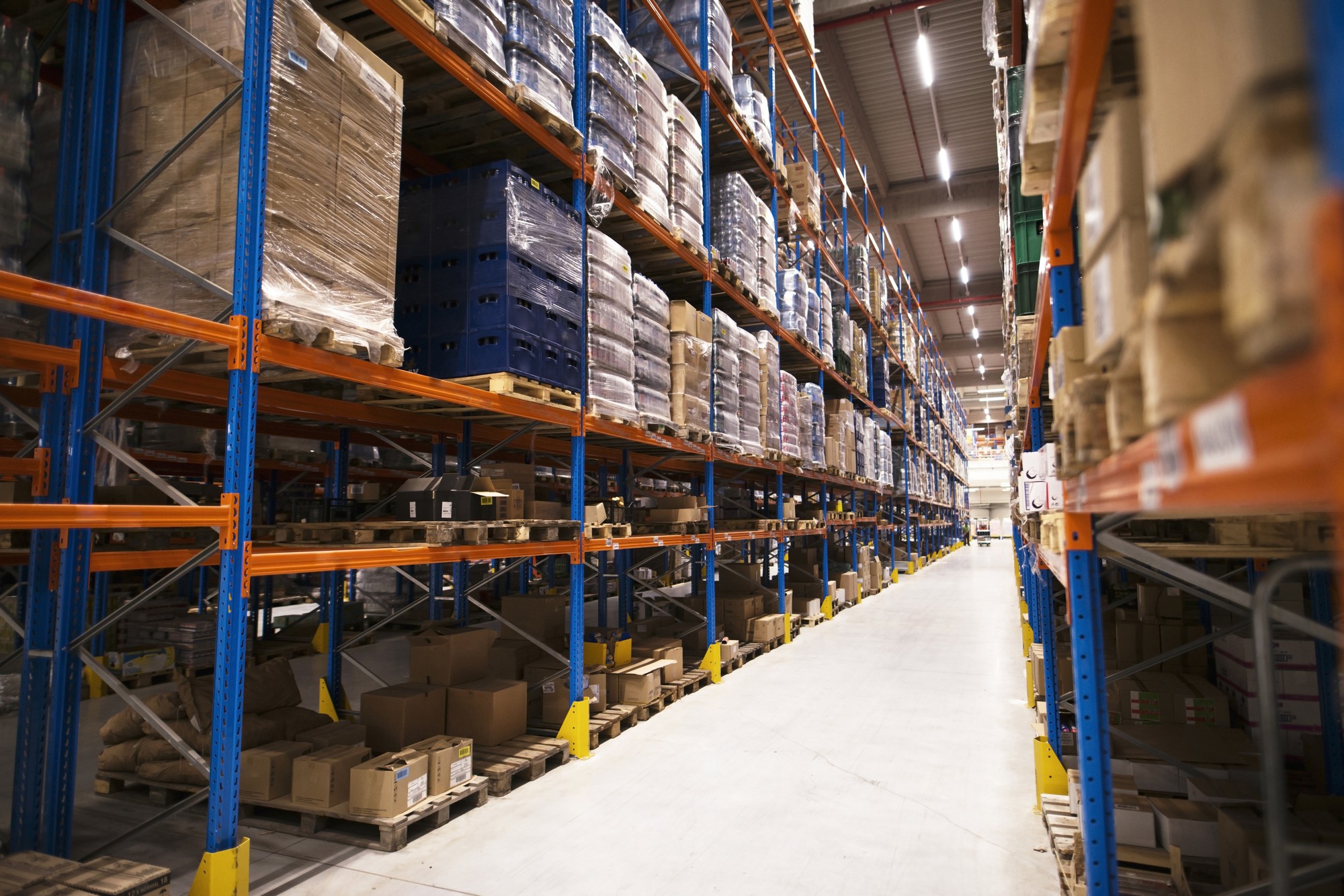 Warehouse aisles with goods stacked on storage racks